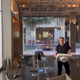 elon musk walking with a sink into the Twitter offices, surrounded by desks and the giant Twitter symbol